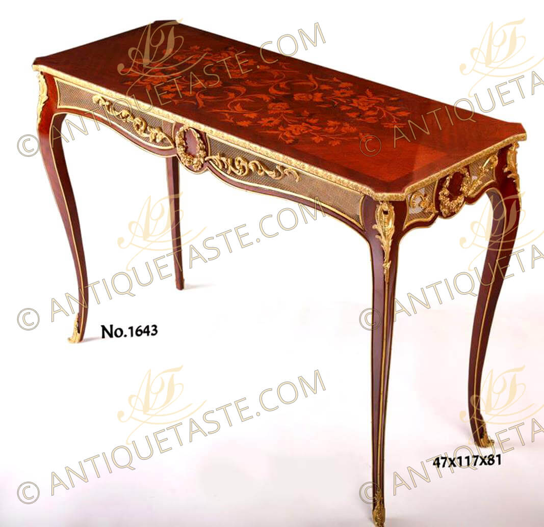 An incomparable French Louis XV style gilt-ormolu-mounted marquetry and quarter veneer inlaid console table, the beautiful console table is raised on elegant elongated slender cabriole legs headed with highly chiseled pierced scrolled acanthus leaves chutes continue with an ormolu band to the leafy ormolu sabots, surmounted by the marvelous scalloped shaped ormolu bordered pierced ormolu gallery apron centered with a wonderfully executed circular tied laurel wreath issuing foliage scrolls, the sides have the same design in a narrower scale, an ormolu band is following the contour of all the scalloped bombée design, all below hammered ormolu borders surrounding the exquisite top professionally inlaid with quarter marquetry on quarter veneered top representing foliage amidst scrolls, the console table is available without marquetry inlaying on top as well as displayed per request